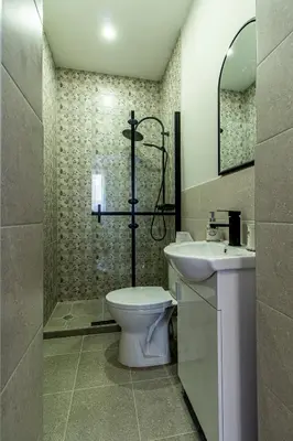 a bathroom with a toilet and a sink and a shower at Eiffel Elegance - Stylish Sofia Apartment in Sofia