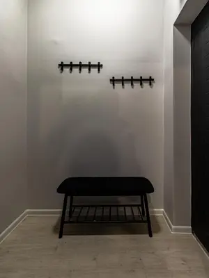 a bench sitting in a room with a white wall at Louvre Loft: Charming Studio in Central Sofia in Sofia
