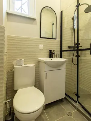 a bathroom with a toilet and a sink at Louvre Loft: Charming Studio in Central Sofia in Sofia