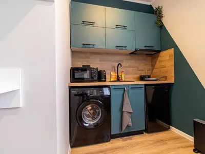 a laundry room with a washer and dryer at Louvre Loft: Charming Studio in Central Sofia in Sofia