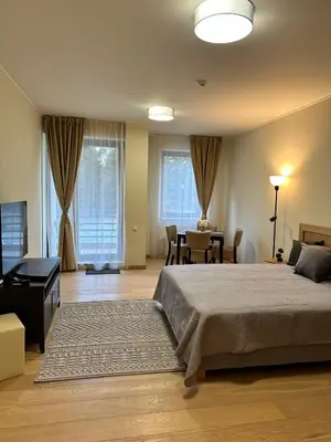 a bedroom with a bed and a table and chairs at Lodge Euphoria Studio in Borovets