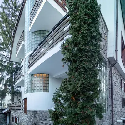 a christmas tree on the side of a building at Eight Rooms Bansko in Bansko