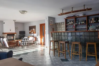 a living room with a library with tables and chairs at Eight Rooms Bansko in Bansko