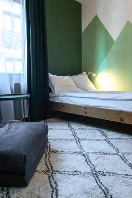 a bedroom with a bed and a window at Eight Rooms Bansko in Bansko