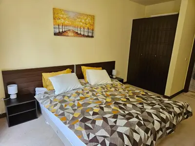 a bedroom with a bed with a quilt on it at TERRA KOMPLEX D3 - Private apartment - Golf, Skiing & SPA in Razlog