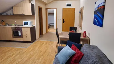 a living room with a couch and a kitchen at Aspen Suites A403 - Sky & Stars Dreamers in Razlog
