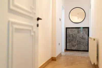 a hallway with a mirror and a painting on the wall at Luxury rooms 12-1 in Plovdiv