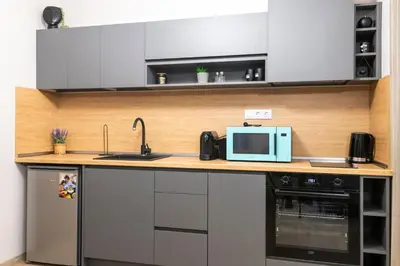 a kitchen with a sink and a microwave at Apartmenthaus Oborishte in Panagyurishte