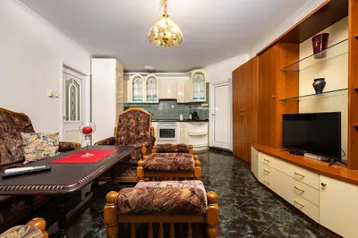 a living room with a dining room table and a kitchen at A Nostalgic Getaway in Plovdiv's Historic Quarter by Flat Mаnager in Plovdiv