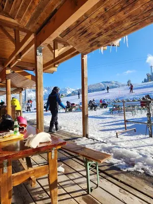 a person standing in the snow at a ski resort at One Bedroom Apartment Pirin Lodge in Bansko
