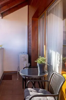 a table with a potted plant on a balcony at One Bedroom Apartment Pirin Lodge in Bansko