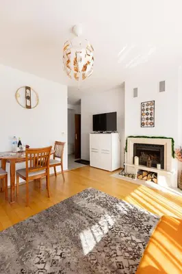 a living room with a table and a fireplace at One Bedroom Apartment Pirin Lodge in Bansko