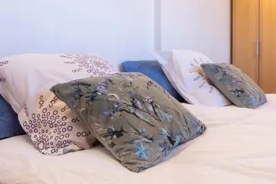 a bed with two pillows and a blanket on it at One Bedroom Apartment Pirin Lodge in Bansko
