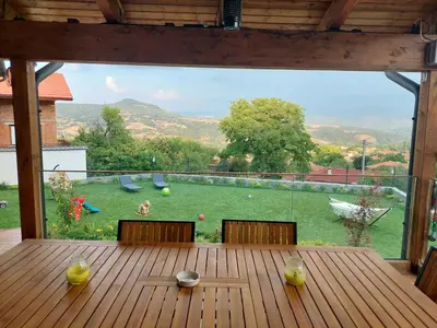 a wooden table with a view of a yard at Relax Srednogorska Panorama in Smolsko