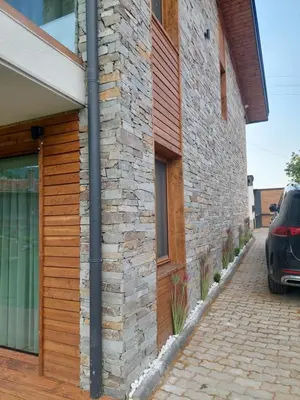 a stone building with a car parked next to it at Relax Srednogorska Panorama in Smolsko