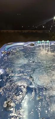 a swimming pool filled with water at night at Relax Srednogorska Panorama in Smolsko