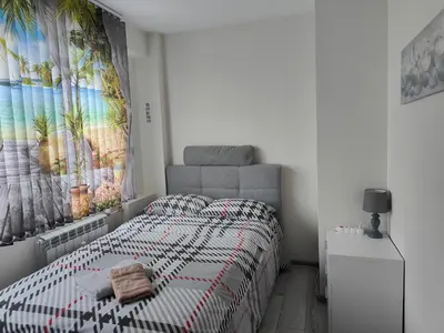a bedroom with a bed and a large painting on the wall at Newly renovated 2 bedroom apartment in Sofia in Sofia