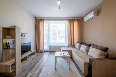a living room with a couch and a tv at Cozy Homes 1 in Sofia