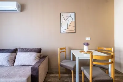 a living room with a couch and a table and chairs at Cozy Homes 1 in Sofia