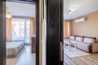 a living room with a couch and a bed at Cozy Homes 1 in Sofia