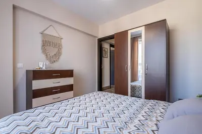 a bedroom with a large bed and a mirror at Cozy Homes 1 in Sofia