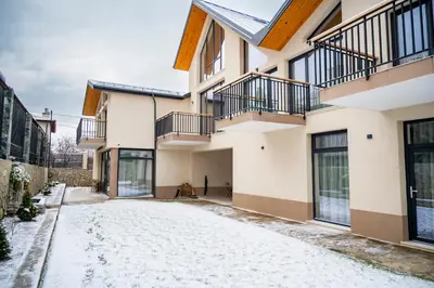 a snow covered driveway in front of a house at Villa Doma in Sapareva Banya