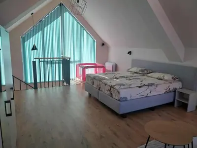 a bedroom with a bed and a large window at Villa Doma in Sapareva Banya