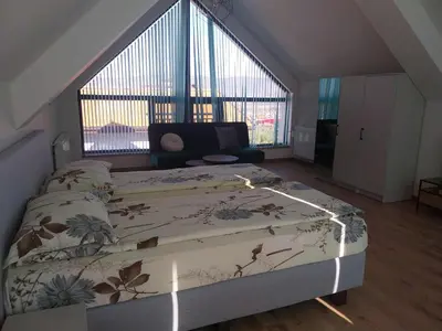 a bedroom with a bed and a large window at Villa Doma in Sapareva Banya