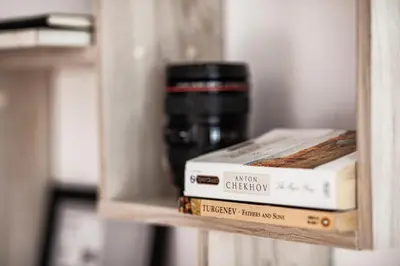 a shelf with two books and a coffee mug at White Сozy Studio A next to the Gondola in Bansko