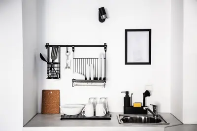 a kitchen counter with a sink and a mirror at White Сozy Studio A next to the Gondola in Bansko