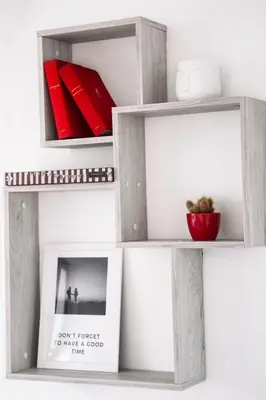 a shelf with two pictures and a book at White Сozy Studio A next to the Gondola in Bansko