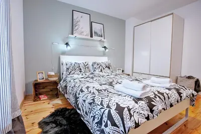 a bedroom with a large bed with pillows on it at Artiesta - 5 apartments in Sofia