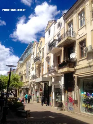 a group of buildings on a city street at Artiesta - 5 apartments in Sofia