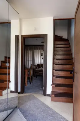 a hallway with a staircase and a living room at Martini villa Lake in Razlog