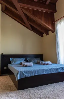 a bedroom with a bed with two pillows on it at Martini villa Lake in Razlog