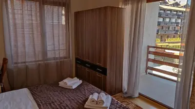 a hotel room with a bed with towels on it at Predela 1 in Bansko