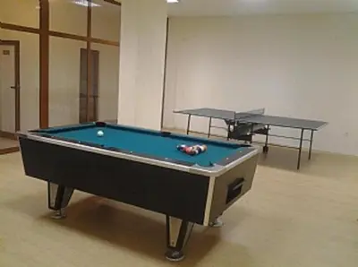 a pool table in a room with two tables at Predela 1 in Bansko