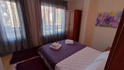 a bedroom with a bed with two towels on it at Predela 1 in Bansko