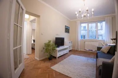 a living room with a blue couch and a tv at Planeta dos sonhos - Fast Wi-Fi, 1BDR, Top centre in Sofia