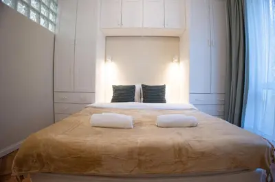 a bedroom with a large bed with two white towels at Planeta dos sonhos - Fast Wi-Fi, 1BDR, Top centre in Sofia