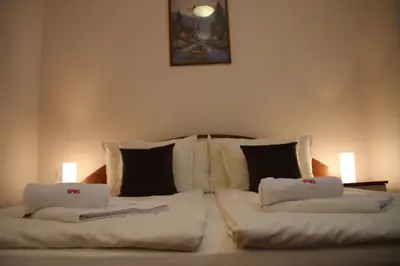 a large white bed with two pillows on it at Charming one bed apartment 423 in main Flora building in Borovets