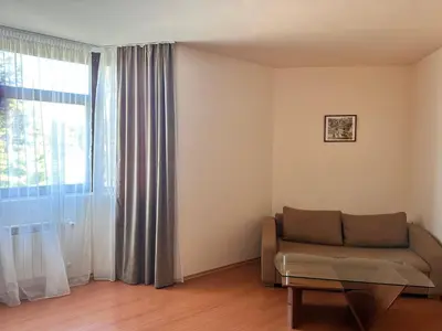 a living room with a couch and a window at Charming one bed apartment 423 in main Flora building in Borovets