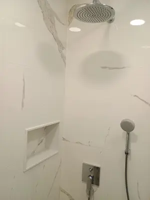 a white bathroom with a shower and a sink at Luxury rooms 12-2 in Plovdiv