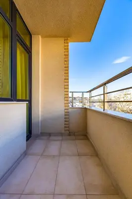 an empty balcony of a building with windows at Radiant Retreat - Bright 1BD Haven in Plovdiv by Flat Mаnager in Plovdiv