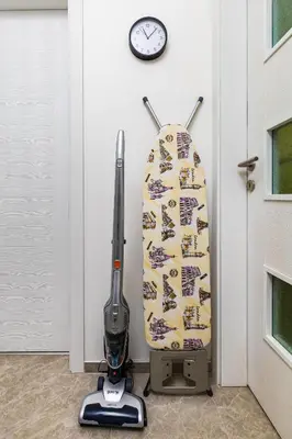 a surfboard leaned up against a wall with a vacuum at Radiant Retreat - Bright 1BD Haven in Plovdiv by Flat Mаnager in Plovdiv