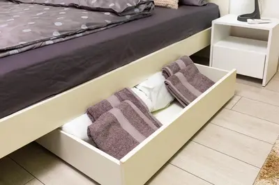 a bedroom with a bed with white drawers and purple towels at Radiant Retreat - Bright 1BD Haven in Plovdiv by Flat Mаnager in Plovdiv