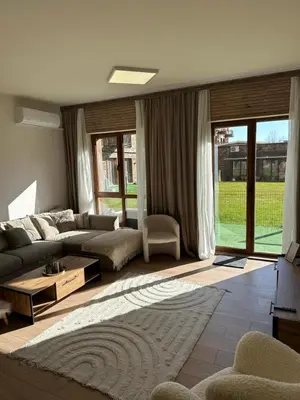 a living room with a couch and a table at Apart-Hotel Crown Bansko 2 in Bansko