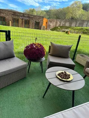 a patio with two chairs and a table with a bowl on it at Apart-Hotel Crown Bansko 2 in Bansko
