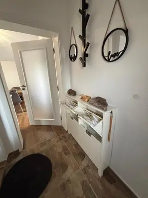 a kitchen with a white cabinet and a mirror on the wall at Charming City Apartment SIYANA - Self Check-in in Panagyurishte