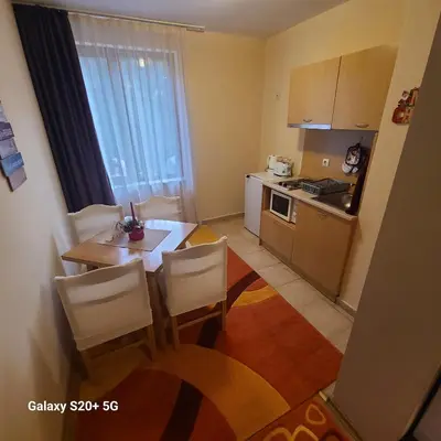 a small kitchen with a table and chairs in a room at The Castle Bonko in Pamporovo